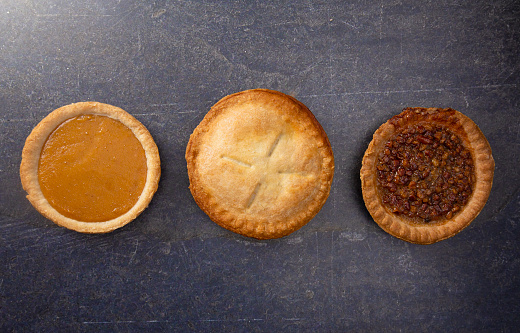 A Holiday Table Set with Various Flavors of Fresh Baked Pies