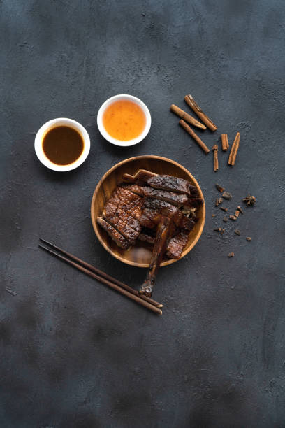 istock chinese roasted duck with dark background 1058206492