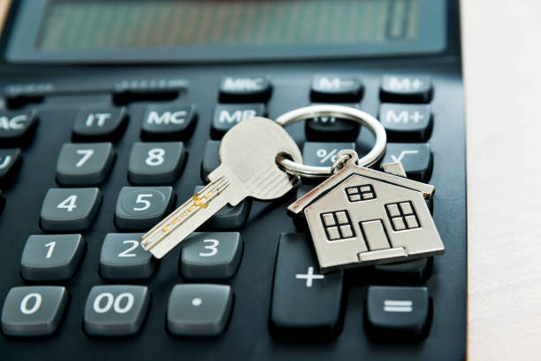 istock Calculator and house key on wooden table 1058206626