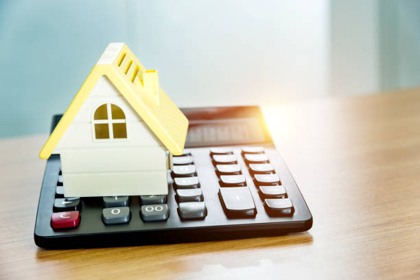 istock Model house and calculator on wooden table 1058206656