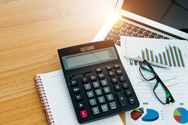 istock Calculator, laptop and other office supply on desk 1058207064