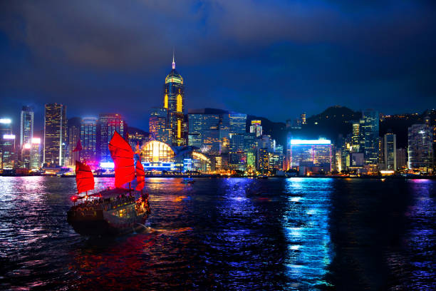 istock Victoria Harbour Hong Kong night view with junk ship on foreground
