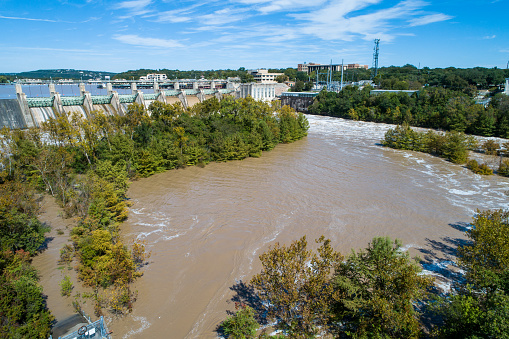 Aerial drone view at the Dam Releasing Flood waters - Austin Flooding fast moving dirty water - Austin Flooding at Tom Miller Dam