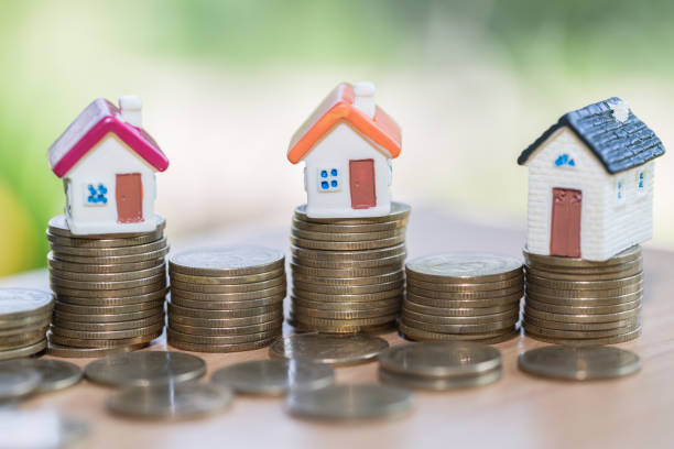 istock House model on coins stacks with calculator as background. Concept for property ladder, mortgage and real estate investment. 1058211234