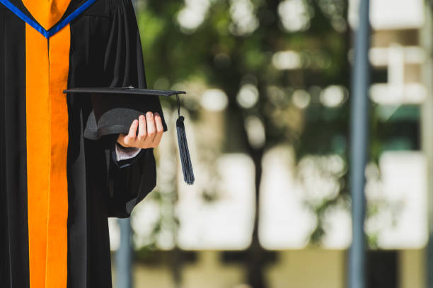 istock Close up Graduate holding a hat. Concept sucess education in University. 1058214516