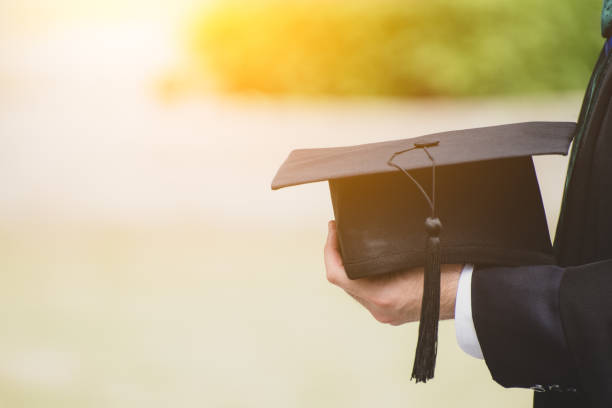 istock Close up Graduate holding a hat. Concept sucess education in University. 1058214556