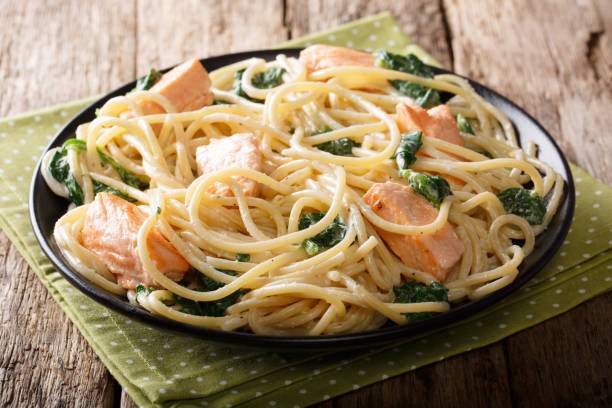 istock serving of spaghetti with salmon, cream cheese and spinach closeup. horizontal 1058216202