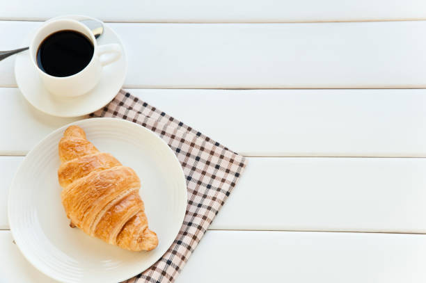 istock croissant and coffee 1058216264