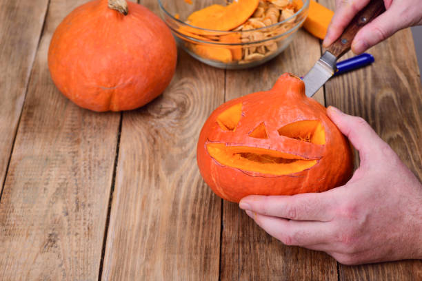 istock The first pumpkin is almost ready. Making a pumpkin lantern for Halloween. 1058216306