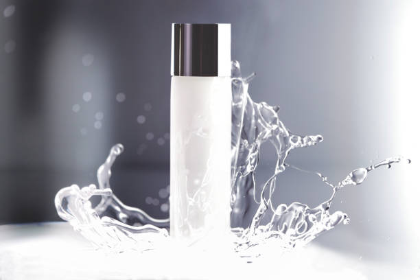 a white cosmetic bottle with water splash a white packaging of cosmetic product was setup for shooting with water splash in studio wet bottle stock pictures, royalty-free photos & images