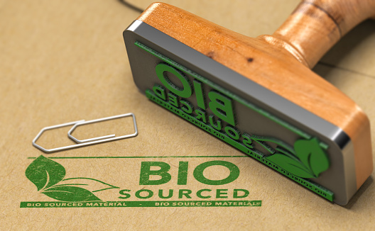 Biocourced material stamped with green color on paper background with rubber stamp. 3D illustration.