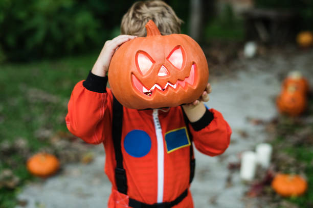 istock Little kid with Halloween pumpkin 1058218290
