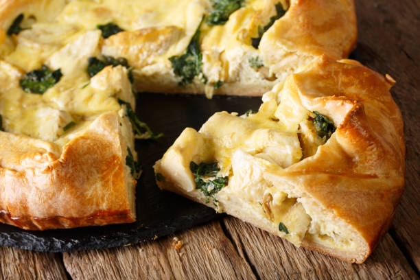 istock Sliced pie with artichokes, cheese and spinach close-up. horizontal 1058218540