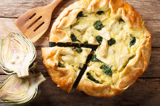 istock tasty pie with artichokes and spinach close-up. horizontal top view from above 1058218744