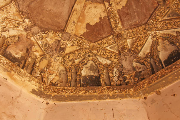 istock Queen baths in Hampi, Karnataka state, India. Carving stone ancient background. Unesco World Heritage Site. Geometric carved patterns on the ceiling 1058223340