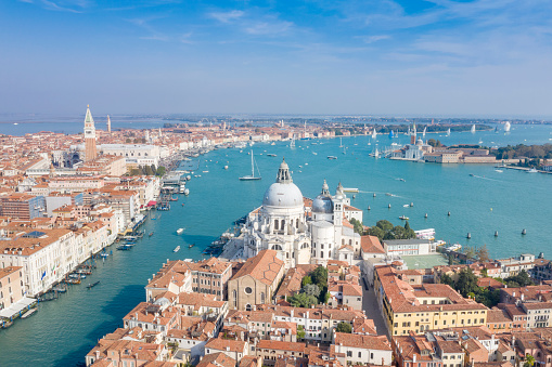 Aerial of the stunning Venice skyline with the most famous tourist attractions and the Veleziana Regatta in back. Converted from RAW.