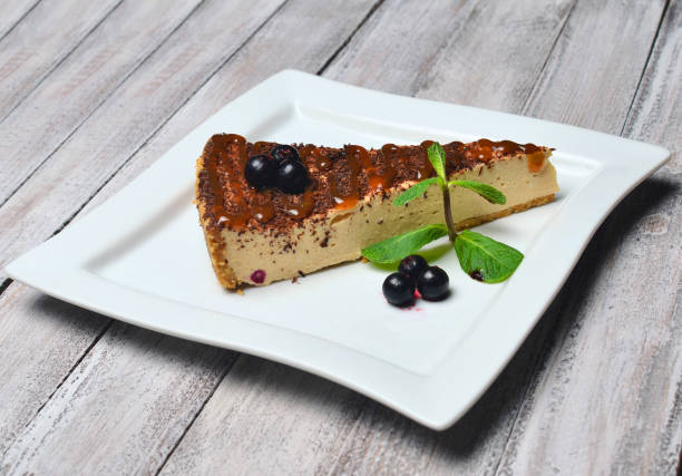 istock Cheesecake with chocolate on a wooden table. 1058225512