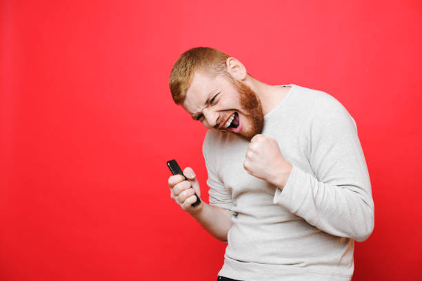 istock Man with smartphone celebrating success 1058225994