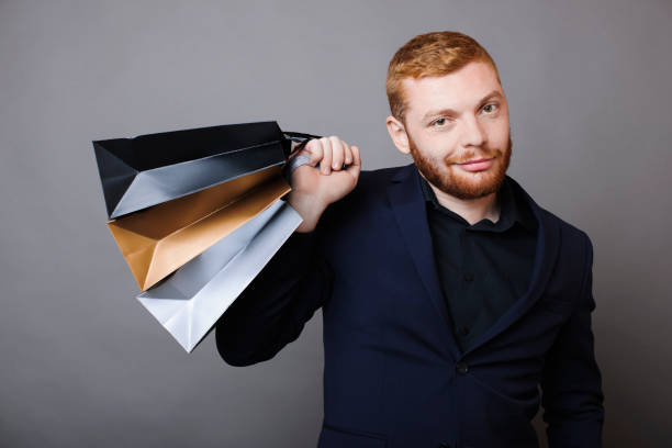 istock Confident guy with paper bags 1058225998