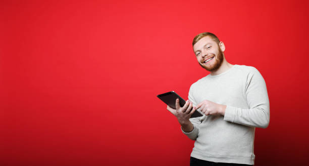 Cheerful man with tablet looking at camera