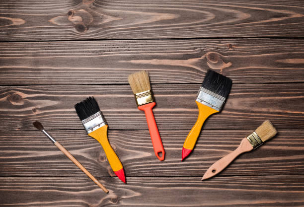 istock Painting brushes on a wooden table. 1058226698