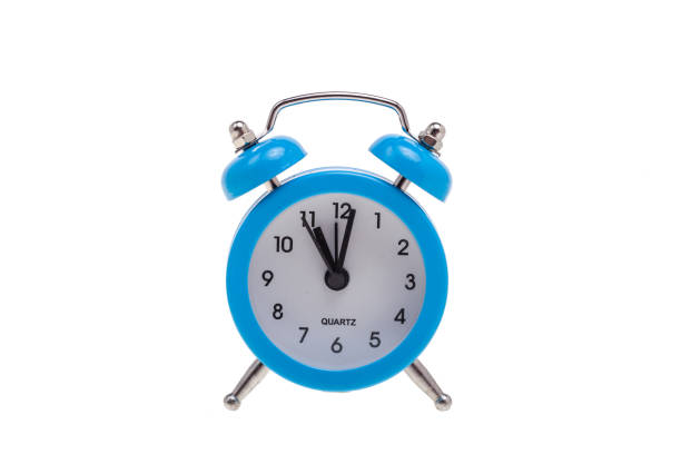 istock One small alarm clock on white, concept of being in time 1058230340