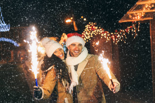 istock Young couple having fun with sparkling candles at night 1058231924