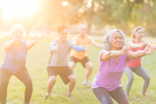 istock Co-ed group exercising together outside in the morning 1058232854