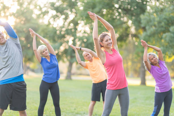 istock Co-ed group exercising together outside in the morning 1058232874
