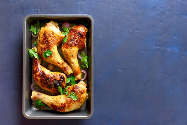 istock Grilled chicken legs in baking tray 1058236844