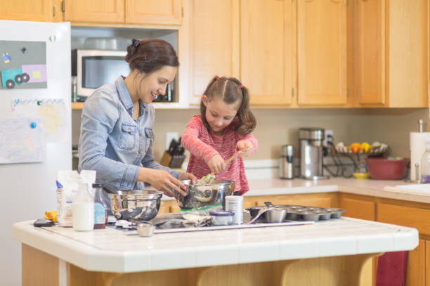 istock Mom teaches her young daughter how to bake 1058238248