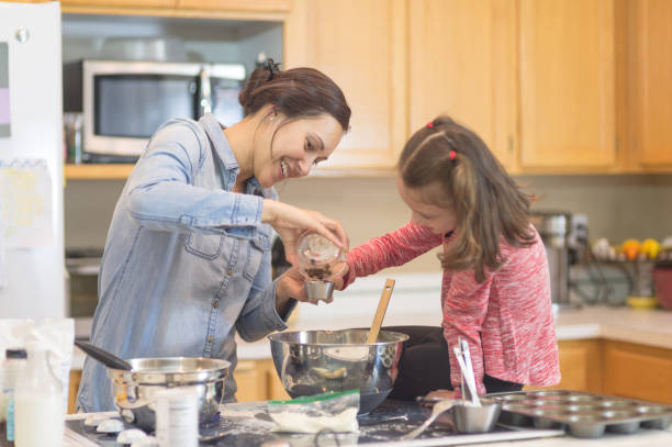 istock Mom teaches her young daughter how to bake 1058238266