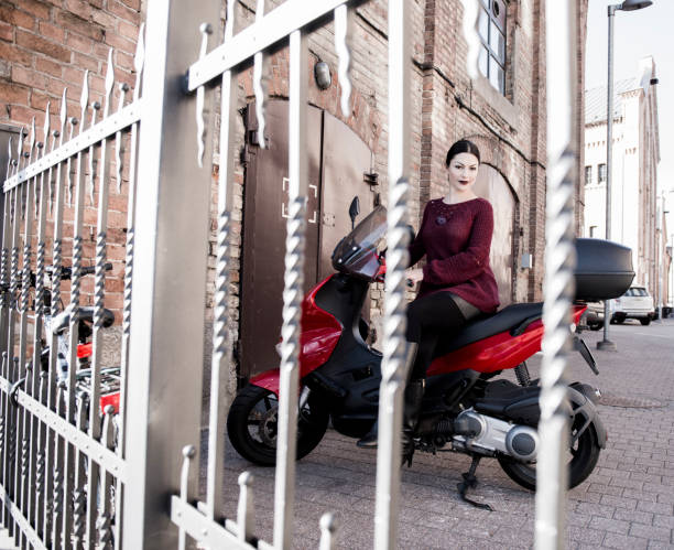istock The beautiful brunette poses on a motor scooter 1058238418