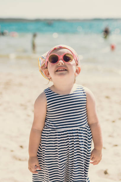 istock Smiling little girl on beach 1058241242