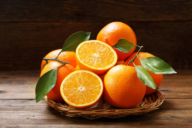 istock fresh orange fruits on wooden table 1058241350