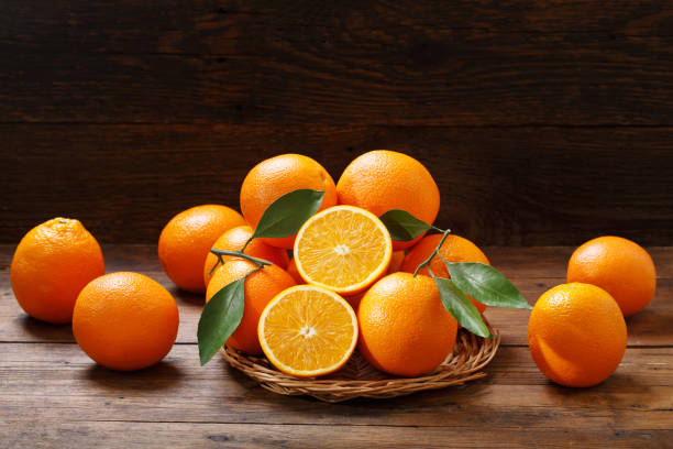 istock fresh orange fruits on wooden table 1058241374