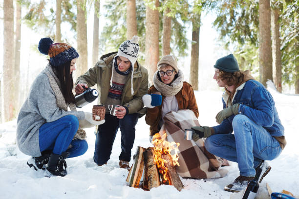 istock Young People Camping in Winter Forest 1058241782