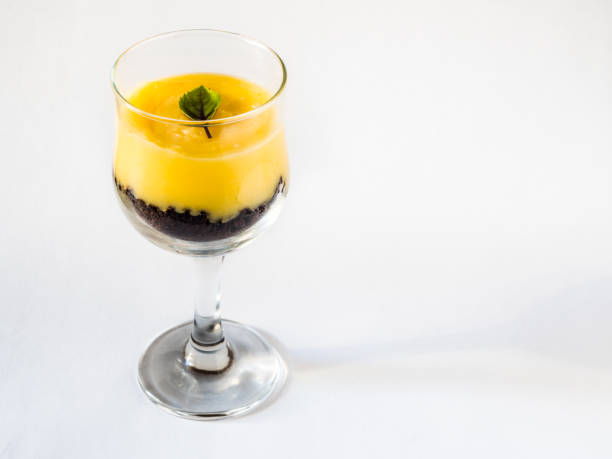 istock Lemon cream dessert presented in a glass with lemon fruit and white background 1058244568