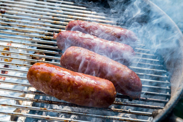 istock Sausages cook on the grill 1058257916