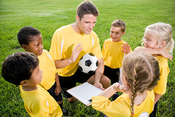 istock Coach and young children on soccer field 105825947