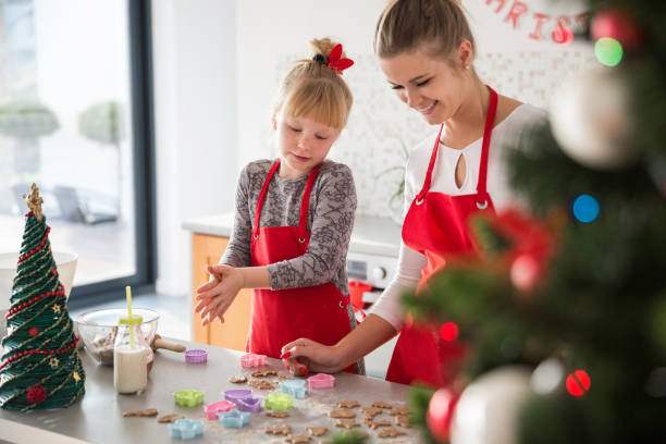 istock Mother and daughter making christmas cookies 1058263138