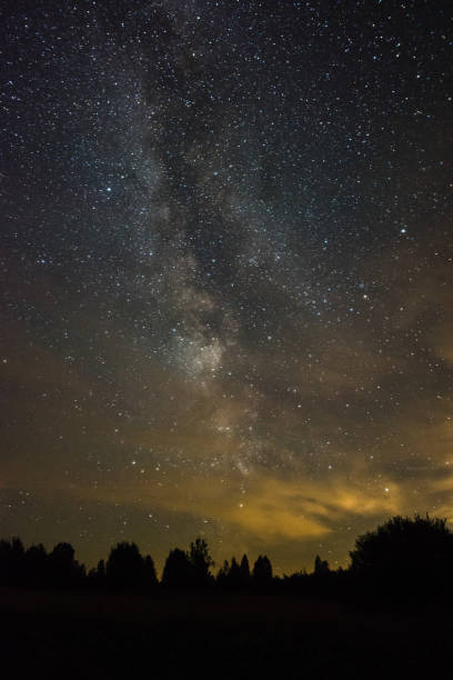 istock Bright milky way on a summer night through the clouds 1058265334