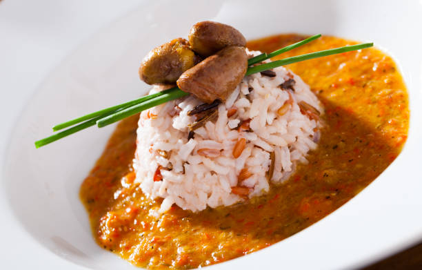 istock Fried chicken hearts with rice and tomato cream sauce 1058265532