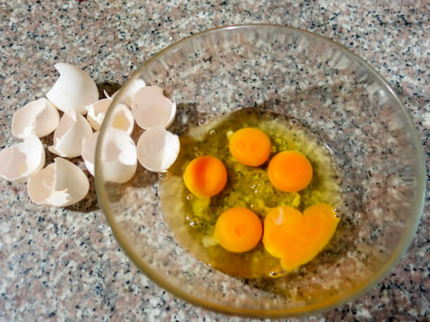 istock Egg yolks and shells in a glass bowl 1058266152