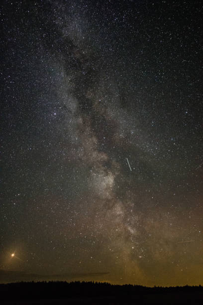 istock Bright milky way on a summer night through the clouds 1058266942