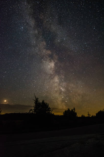 istock Bright milky way on a summer night through the clouds 1058266952