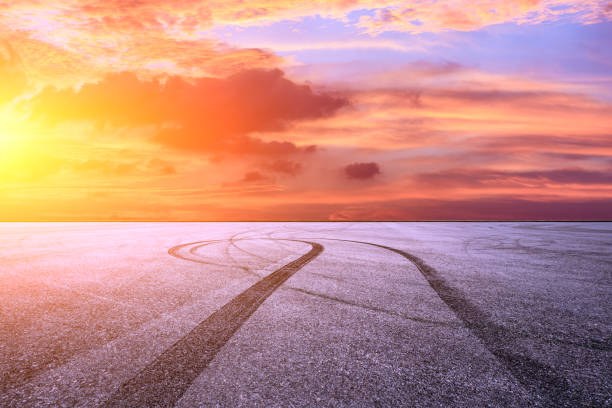 istock Car racing track asphalt square and beautiful sky clouds scenery at sunset 1058269714