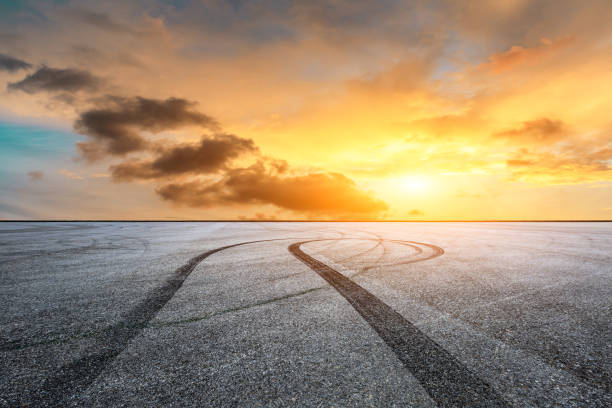 istock Car racing track asphalt square and beautiful sky clouds scenery at sunset 1058270004