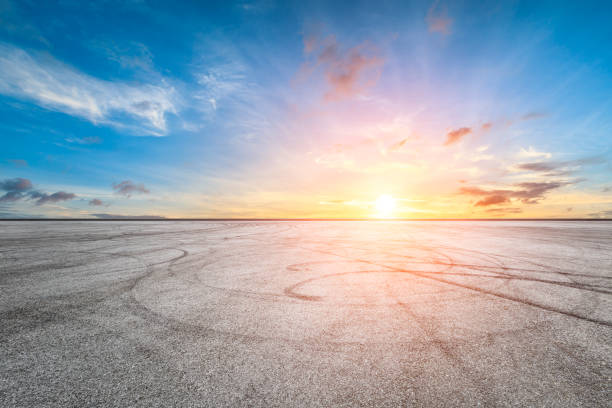 istock Car racing track asphalt square and beautiful sky clouds scenery at sunset 1058270410