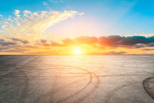 istock Car racing track asphalt square and beautiful sky clouds scenery at sunset 1058271146